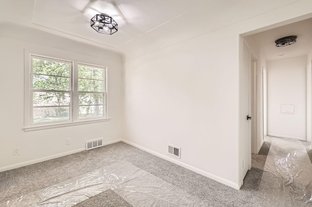 empty room featuring carpet flooring and baseboards
