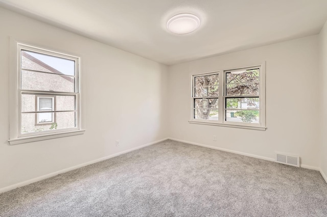 carpeted empty room with baseboards