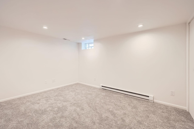 below grade area with a baseboard heating unit, carpet flooring, recessed lighting, and baseboards