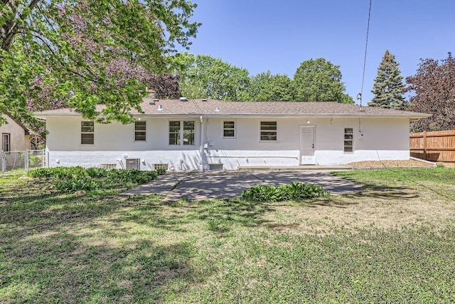 back of house with stucco siding and a patio
