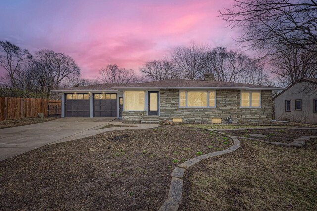 single story home featuring stone siding, fence, a chimney, a garage, and entry steps