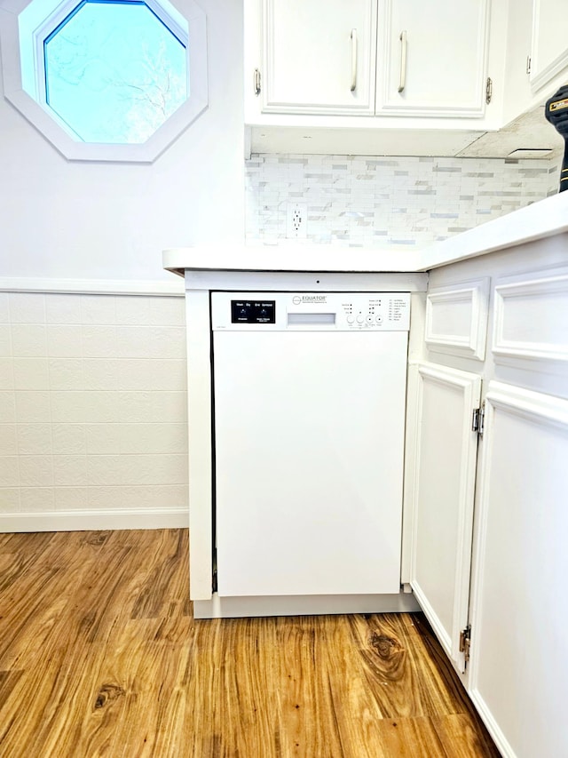 kitchen featuring dishwasher, light countertops, light wood-type flooring, and white cabinetry