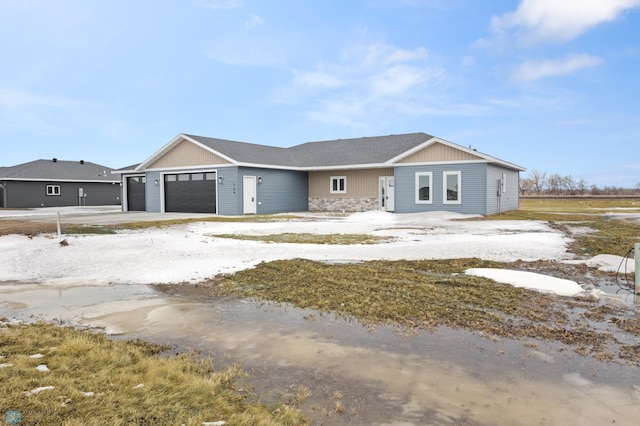 view of front of property featuring stone siding and an attached garage