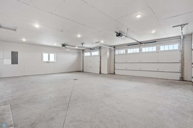 garage with electric panel and a garage door opener