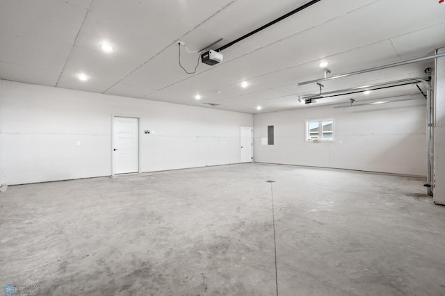 garage featuring electric panel and a garage door opener