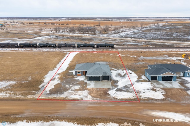 snowy aerial view featuring a rural view