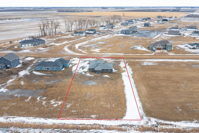 snowy aerial view with a rural view and a residential view