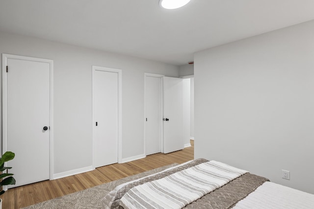 bedroom with baseboards and wood finished floors