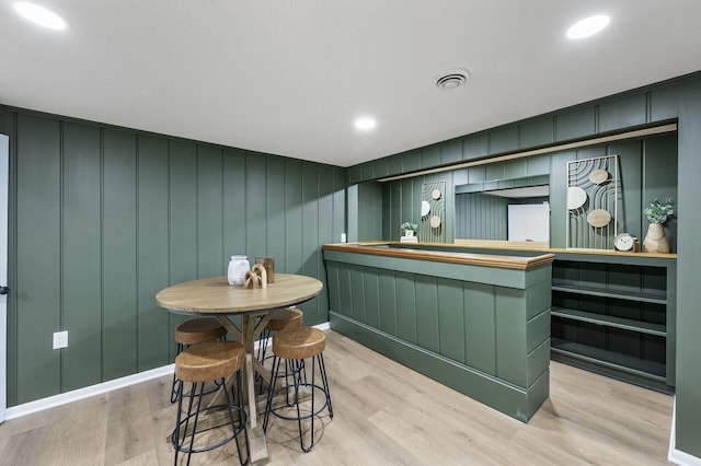 bar featuring light wood finished floors, visible vents, and recessed lighting