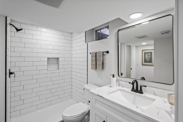 full bathroom with tiled shower, visible vents, toilet, and a textured ceiling