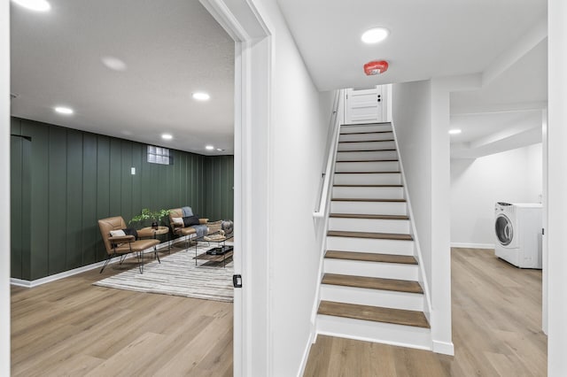 stairs with washer / clothes dryer, recessed lighting, wood finished floors, and baseboards