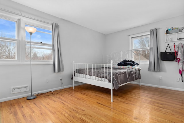 bedroom featuring light wood-style flooring and baseboards