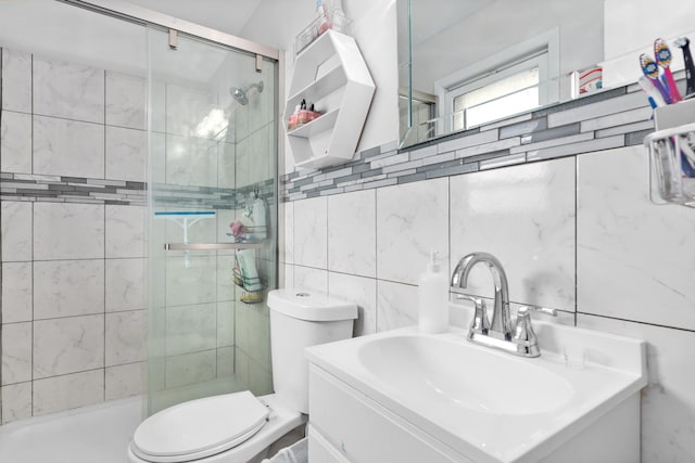 full bathroom with tile walls, a shower stall, toilet, decorative backsplash, and vanity