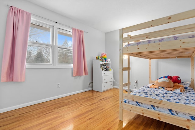 bedroom with wood finished floors and baseboards