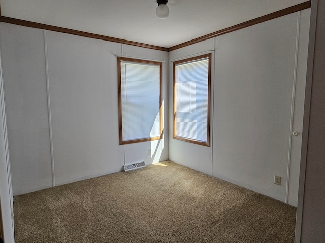 empty room featuring carpet floors and visible vents