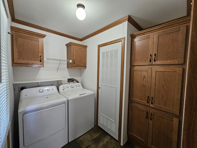 laundry room with ornamental molding, dark wood-type flooring, cabinet space, and washer and dryer