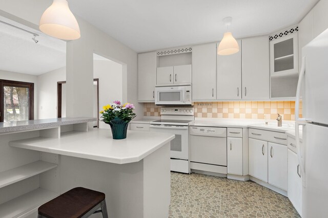 1021 Yuma Ln N, Plymouth, MN 55447 - kitchen with white appliances, light countertops, backsplash, a breakfast bar area, and hanging light fixtures