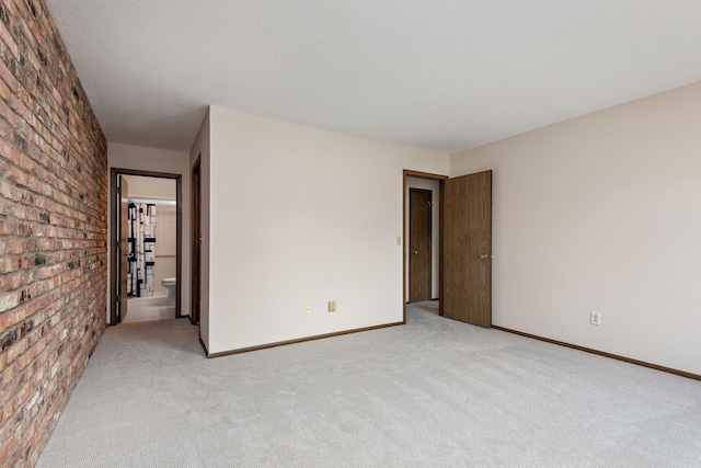 1021 Yuma Ln N, Plymouth, MN 55447 - unfurnished room featuring brick wall and light carpet