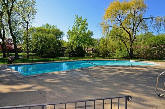 1021 Yuma Ln N, Plymouth, MN 55447 - view of swimming pool featuring a patio and view of wooded area