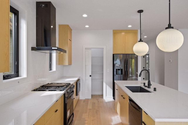 kitchen with a sink, light brown cabinetry, wall chimney exhaust hood, black appliances, and modern cabinets