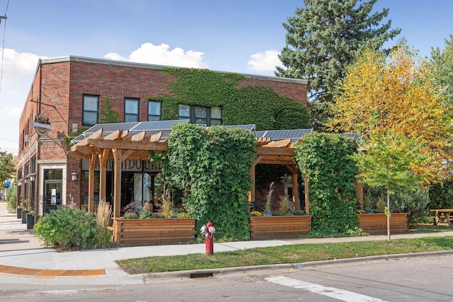 exterior space with a pergola and brick siding