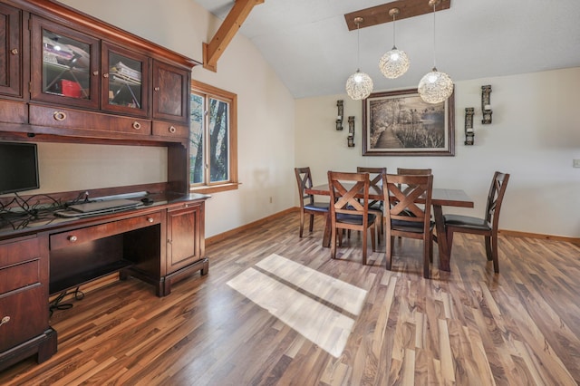 dining area with wood finished floors, baseboards, and lofted ceiling