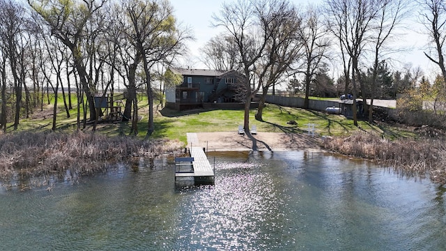 dock area featuring a lawn and a water view
