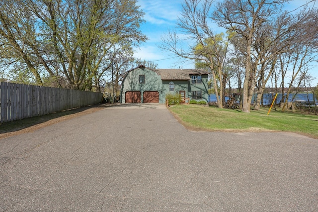 exterior space with a barn and aphalt driveway