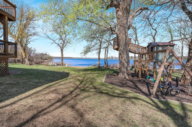 view of yard featuring a playground and a water view