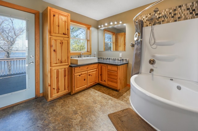 full bathroom featuring vanity, tile patterned floors, baseboards, and shower / bathtub combination