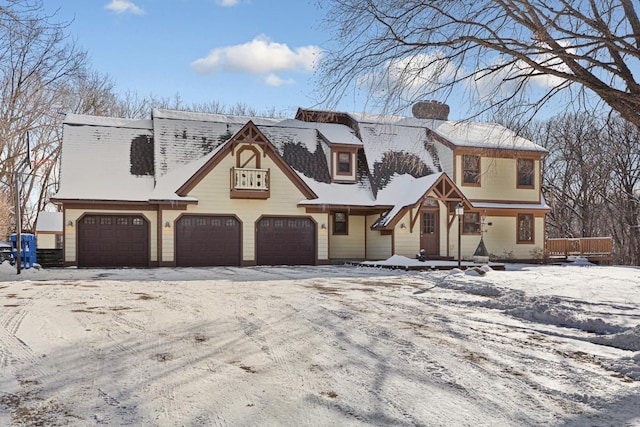 view of front of house with a garage, driveway, and a chimney