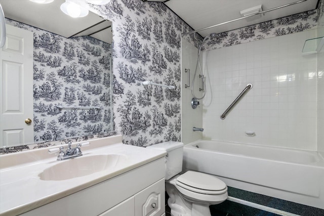 bathroom featuring vanity, toilet, and wallpapered walls