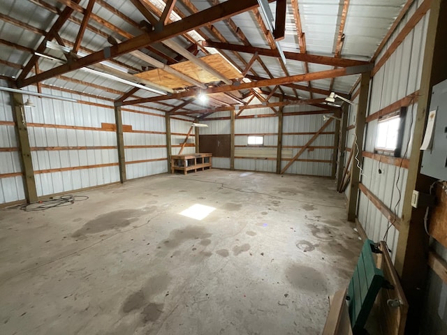 garage featuring electric panel and metal wall