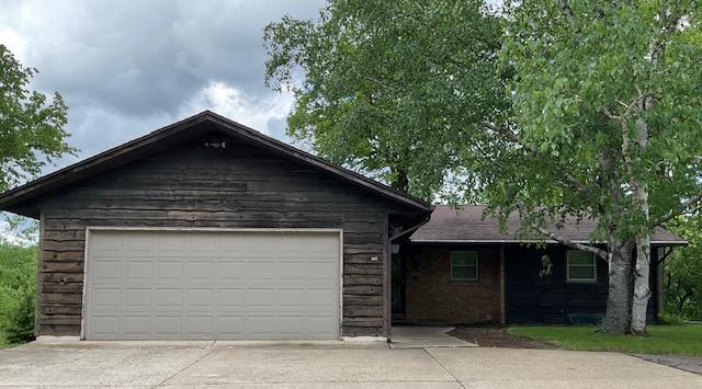 single story home with a garage and driveway