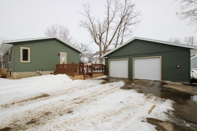 snow covered garage with a garage