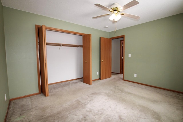 unfurnished bedroom with a closet, light carpet, ceiling fan, and baseboards