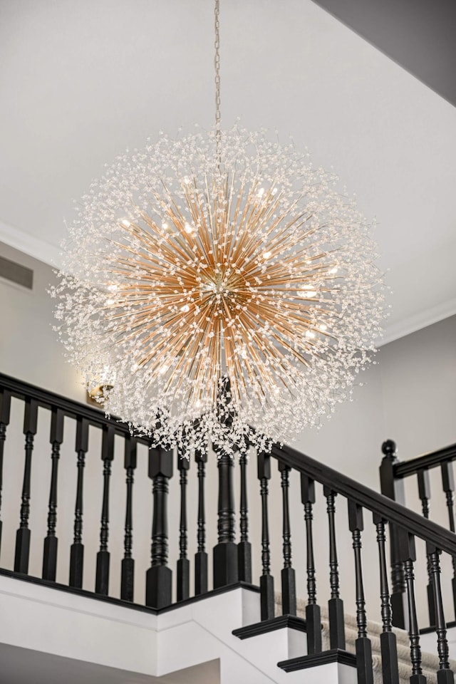 details featuring a chandelier, visible vents, and crown molding