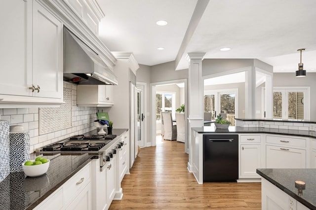 kitchen with stainless steel gas cooktop, decorative columns, light wood-style flooring, white cabinets, and dishwasher