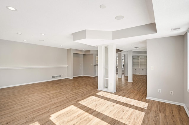 spare room with light wood-type flooring, visible vents, baseboards, and recessed lighting