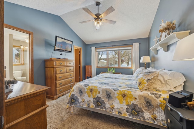 bedroom featuring lofted ceiling, ensuite bath, a textured ceiling, and light colored carpet