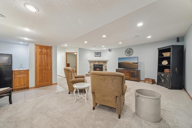 living room featuring light carpet, recessed lighting, and a stone fireplace