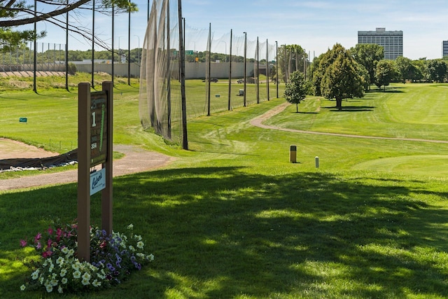 view of community featuring a lawn and fence