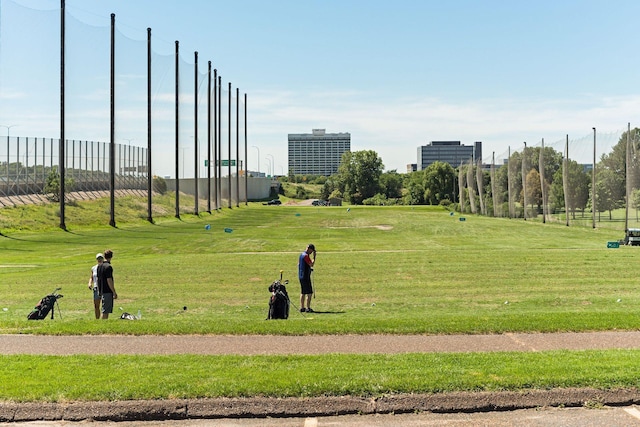 view of property's community with a yard and fence