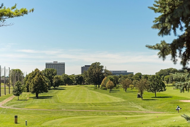 view of home's community featuring a lawn and golf course view