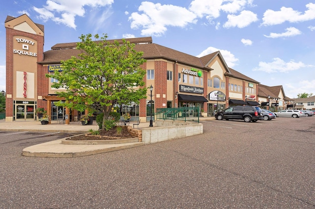 view of property featuring uncovered parking