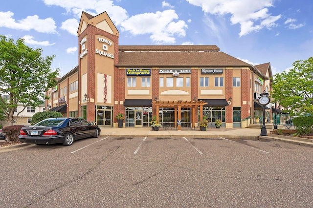 view of building exterior with uncovered parking