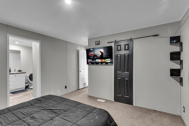 27939 Forest Blvd, Wyoming, MN 55092 - bedroom with light carpet, a barn door, and recessed lighting