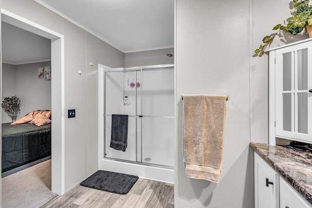 27939 Forest Blvd, Wyoming, MN 55092 - bathroom featuring ornamental molding, wood finished floors, a shower stall, connected bathroom, and vanity
