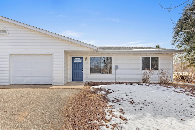 ranch-style home with driveway and an attached garage