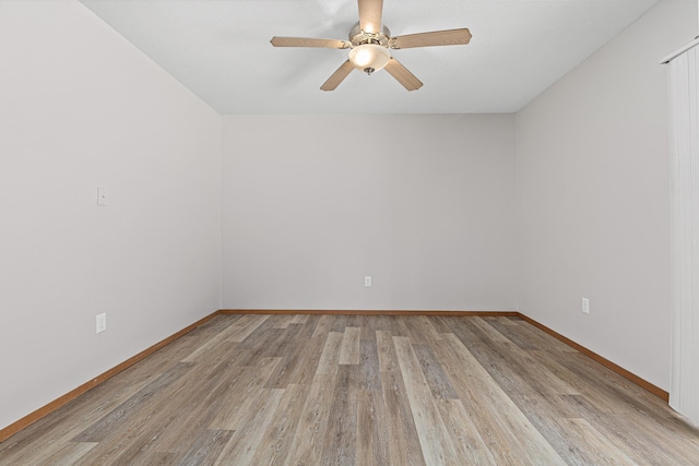 spare room with light wood-style floors, baseboards, and ceiling fan